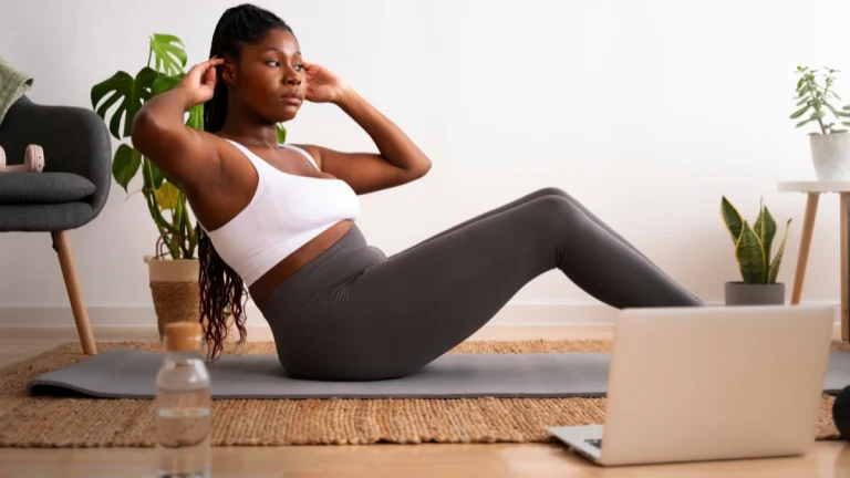 How to Stay Fit Without a Gym: Best At-Home Workouts for Every Fitness Level Full shot woman training with laptop