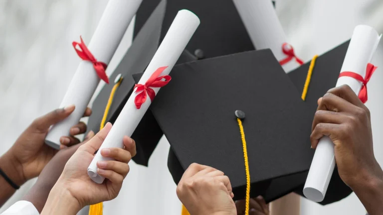 The Top 5 Best Universities in Gauteng for 2025 Graduation - Close up hands holding diplomas and caps