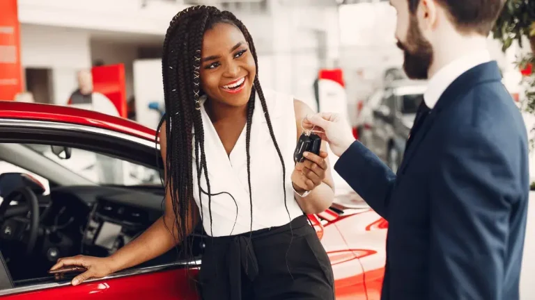 Top 3 Car Brands Dominating the South African Market in 2025 Stylish black woman in a car salon - Black woman getting keys at a car dealership